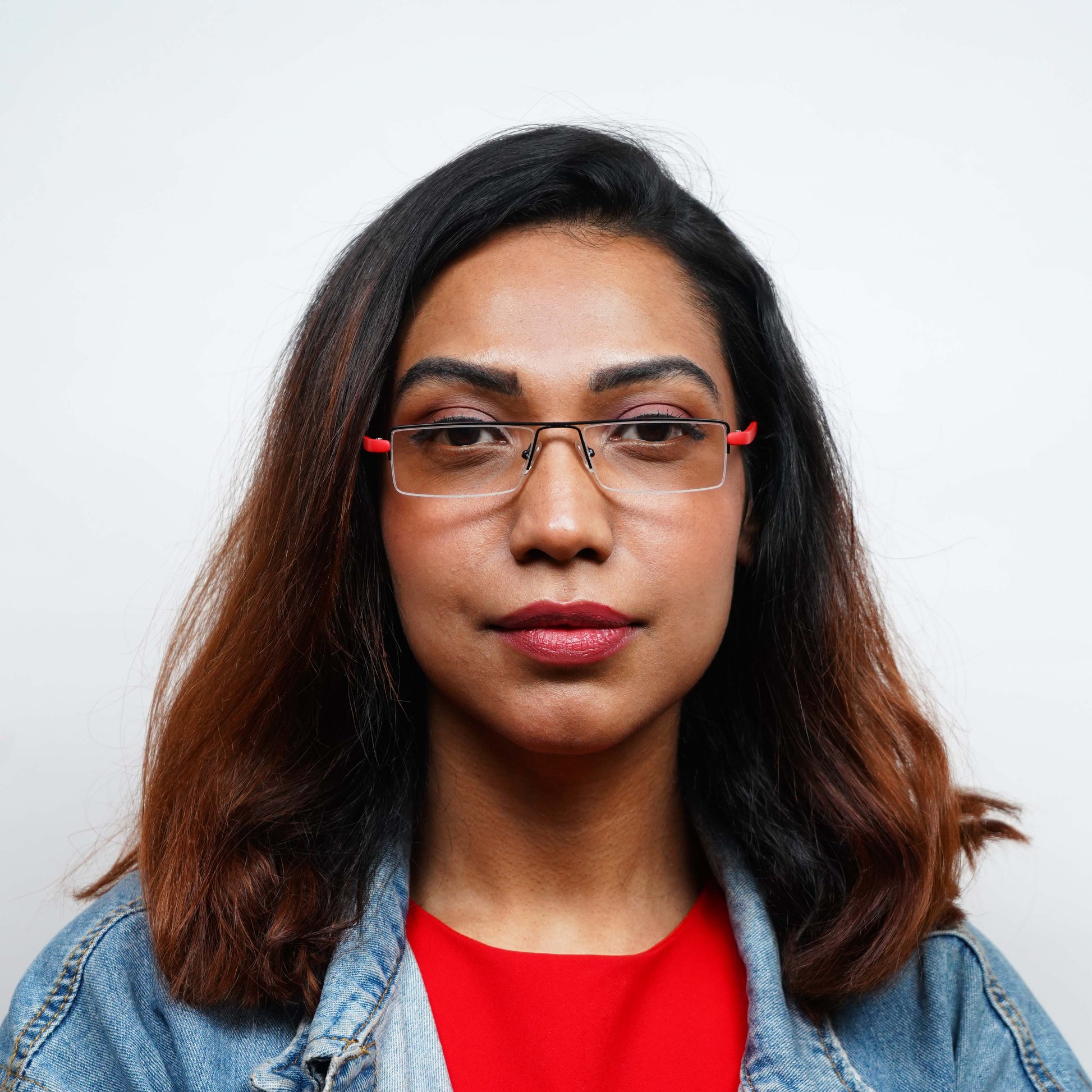 Woman wearing Pagina red, half-rim reading glasses